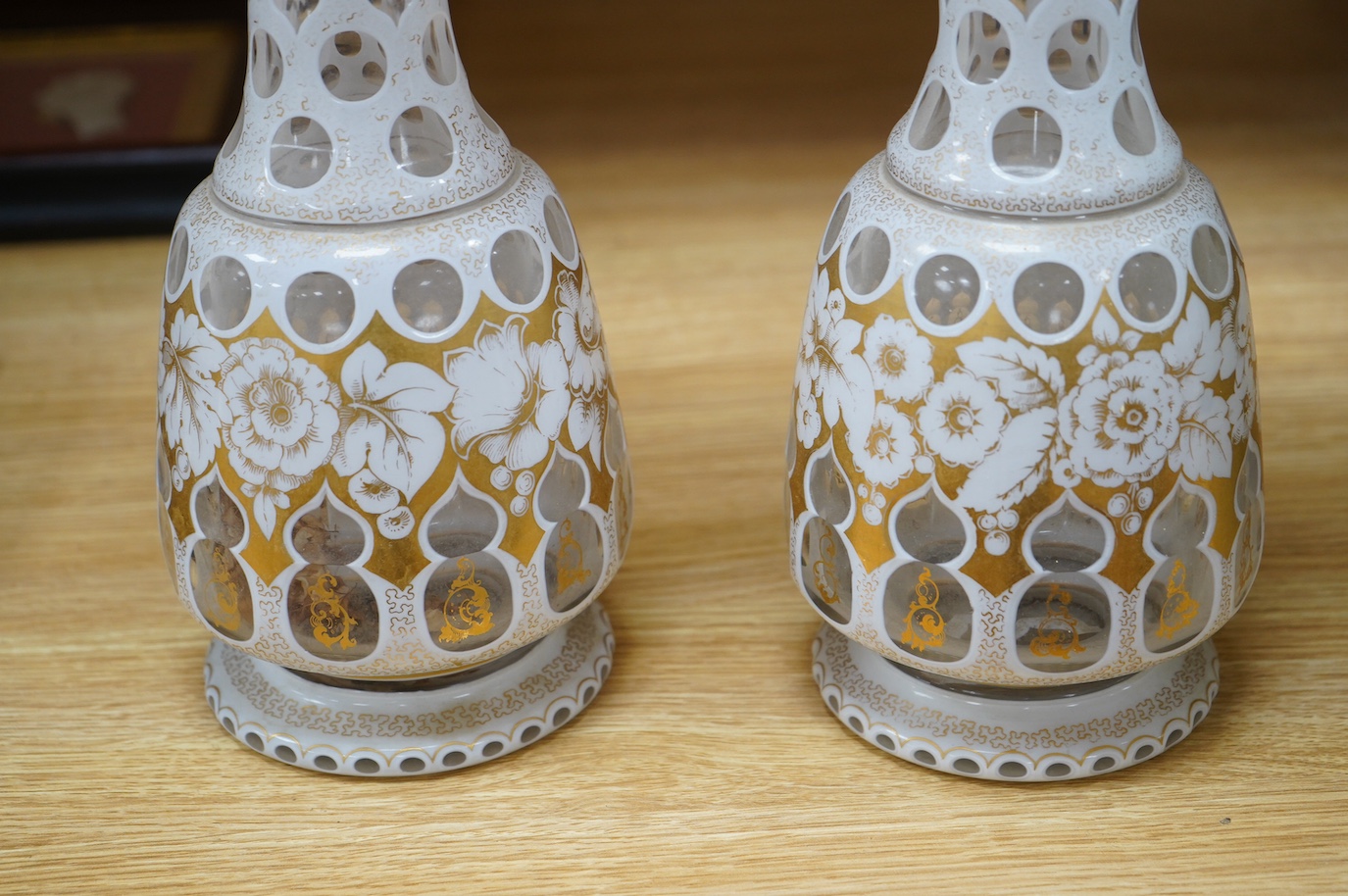 A pair of late 19th century Bohemian overlaid glass vases, 37.5cm. Condition - one has loose (but present) piece at rim